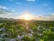 Scenic aerial view of neighborhood homes with lush green trees and distant mountain views at 9123 W Arbor Ave, Littleton, CO 80123