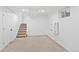 Spacious basement area with carpeted flooring and staircase to the upper level at 9123 W Arbor Ave, Littleton, CO 80123
