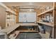 Unfinished basement workshop area with wooden workbenches and shelving at 9123 W Arbor Ave, Littleton, CO 80123