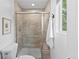 Updated bathroom with tiled shower, glass door, and a window providing natural light at 9123 W Arbor Ave, Littleton, CO 80123