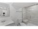 Modern bathroom features tiled shower with glass door, neutral walls, and decorative framed mirror at 9123 W Arbor Ave, Littleton, CO 80123