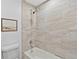 Bathroom with a luxurious soaking tub and shower adorned with elegant neutral tile at 9123 W Arbor Ave, Littleton, CO 80123