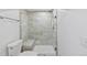 Updated bathroom with a frameless glass shower, bench, and tiled walls at 9123 W Arbor Ave, Littleton, CO 80123