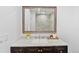 Bathroom vanity with granite countertop, vessel sink, and framed mirror at 9123 W Arbor Ave, Littleton, CO 80123