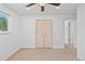 Neutral bedroom featuring a ceiling fan and a closet with double doors at 9123 W Arbor Ave, Littleton, CO 80123