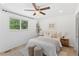 Bright bedroom features a ceiling fan, neutral decor, and a large window with a peaceful outdoor view at 9123 W Arbor Ave, Littleton, CO 80123