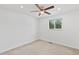 Bright bedroom with a ceiling fan and a window view of lush green trees at 9123 W Arbor Ave, Littleton, CO 80123