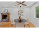 Cozy dining area featuring hardwood floors, modern lighting, and fireplace at 9123 W Arbor Ave, Littleton, CO 80123