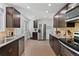 Spacious kitchen with stainless steel appliances, granite countertops, and dark brown cabinets at 9123 W Arbor Ave, Littleton, CO 80123