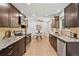 Modern kitchen with granite countertops, tile backsplash, and stainless steel appliances at 9123 W Arbor Ave, Littleton, CO 80123