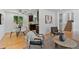 Open-concept living space with hardwood floors, dining area, and stairs to upper level at 9123 W Arbor Ave, Littleton, CO 80123