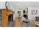 Bright and airy living room with fireplace and views into kitchen and dining area at 9123 W Arbor Ave, Littleton, CO 80123