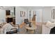 Open-concept living space with hardwood floors, dining area, and stairs to upper level at 9123 W Arbor Ave, Littleton, CO 80123