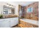 Bathroom featuring granite counters, cabinetry, and soaking tub with shower at 404 S Jasmine St, Denver, CO 80224