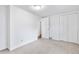 Clean and spacious bedroom offers a neutral carpet, white walls, and closet at 404 S Jasmine St, Denver, CO 80224
