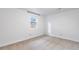 Clean bedroom offers a neutral carpet, white walls, and natural light from a window at 404 S Jasmine St, Denver, CO 80224