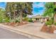 Charming home featuring stone accents, a well-maintained lawn, and a driveway with ample parking space at 404 S Jasmine St, Denver, CO 80224