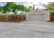 Detached garage with an exterior parking area and a privacy fence enhancing its street view appeal at 404 S Jasmine St, Denver, CO 80224