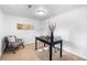 Home office features neutral carpet, white walls, black desk, and comfortable seating at 404 S Jasmine St, Denver, CO 80224
