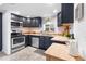 A well-lit kitchen with stainless steel appliances and ample counter space at 404 S Jasmine St, Denver, CO 80224