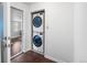 Convenient laundry closet includes a stacked washer and dryer for easy laundry access at 404 S Jasmine St, Denver, CO 80224