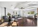 Open-concept living area with vaulted ceilings, hardwood floors, and a cozy wood-burning stove at 404 S Jasmine St, Denver, CO 80224