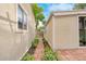 Brick walkway between homes with beautiful landscaping and plants add a charming touch at 404 S Jasmine St, Denver, CO 80224