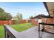 Spacious backyard featuring a wooden deck, lush lawn, wooden fence, and play structure, perfect for outdoor enjoyment at 4293 Graham Ct, Boulder, CO 80305