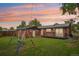 Spacious fenced backyard with a patio, lush lawn, and play set, perfect for outdoor enjoyment at 4293 Graham Ct, Boulder, CO 80305