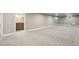 Finished basement with neutral carpeting, updated lighting, and an adjacent bathroom at 4293 Graham Ct, Boulder, CO 80305