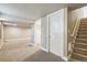 Spacious basement area with neutral carpet, white trim, and stairway to the main level at 4293 Graham Ct, Boulder, CO 80305