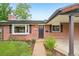 Inviting brick home featuring a covered porch, bay window, and landscaped garden for a welcoming entrance at 4293 Graham Ct, Boulder, CO 80305