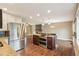 Open floor plan featuring kitchen with stainless appliances, island, and view to the living room fireplace at 4293 Graham Ct, Boulder, CO 80305