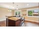 Gourmet kitchen island with granite counters, stainless steel oven, and a built-in cooktop at 4293 Graham Ct, Boulder, CO 80305