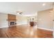 Open-concept living space with hardwood floors, stone fireplace, and kitchen with central island at 4293 Graham Ct, Boulder, CO 80305