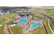 Aerial view of a community center with a pool, water area, and landscaped surroundings at 7173 S Shady Grove Ct, Aurora, CO 80016