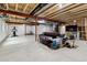 Unfinished basement with concrete floors, exposed ceiling, and exercise equipment, offers customization and expansion opportunities at 7173 S Shady Grove Ct, Aurora, CO 80016