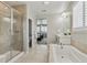 Spa-like bathroom featuring a glass shower, soaking tub, and double vanity at 7173 S Shady Grove Ct, Aurora, CO 80016