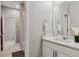 Bright bathroom featuring modern fixtures, a single vanity, and a shower-tub combo at 7173 S Shady Grove Ct, Aurora, CO 80016