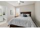 Comfortable bedroom with a ceiling fan, neutral walls and en-suite bathroom at 7173 S Shady Grove Ct, Aurora, CO 80016