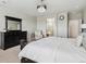 Primary bedroom with elegant furniture and view of the attached bathroom at 7173 S Shady Grove Ct, Aurora, CO 80016