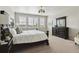 Bright bedroom features neutral tones, large windows, and elegant furnishings at 7173 S Shady Grove Ct, Aurora, CO 80016