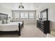 Well-lit bedroom with large windows, plush bedding and stylish dresser at 7173 S Shady Grove Ct, Aurora, CO 80016