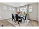 Dining room with table, six chairs, rug, and sliding glass door to outdoor space at 7173 S Shady Grove Ct, Aurora, CO 80016