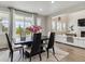 Dining Room boasts modern table, chairs, and sliding glass door to outside at 7173 S Shady Grove Ct, Aurora, CO 80016