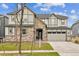 Charming two-story home with stone accents, a well-maintained lawn, and an attached two-car garage at 7173 S Shady Grove Ct, Aurora, CO 80016