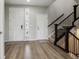 Spacious foyer features hardwood flooring, staircase, and multiple entryways at 7173 S Shady Grove Ct, Aurora, CO 80016