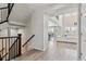Inviting foyer with staircase, hardwood floors, and a view into the bright and open living space at 7173 S Shady Grove Ct, Aurora, CO 80016
