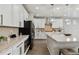 Bright kitchen boasts white cabinets, stainless steel appliances, and granite countertops at 7173 S Shady Grove Ct, Aurora, CO 80016