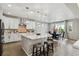Bright kitchen with a center island, stainless steel appliances, and a dining area with outdoor views at 7173 S Shady Grove Ct, Aurora, CO 80016